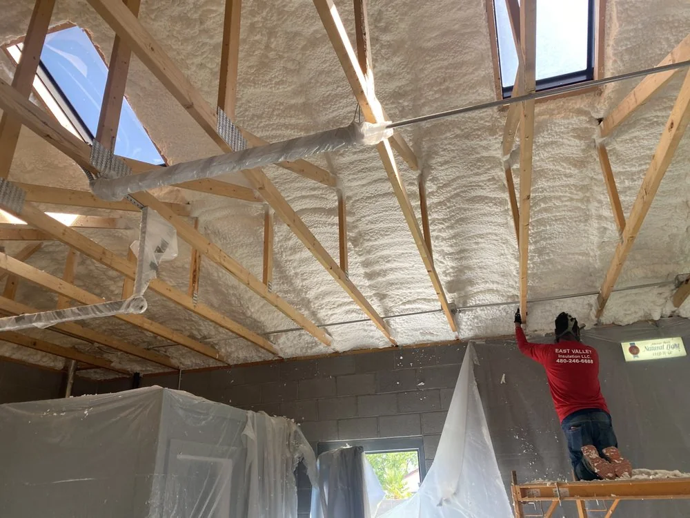 Spray foam insulation installed across ceiling framing